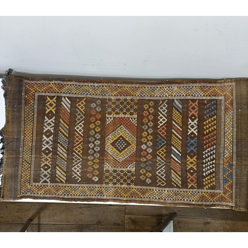 580 - A set of four tribal rugs, with geometric decoration, each 92 x 50 cm (4)