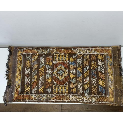 580 - A set of four tribal rugs, with geometric decoration, each 92 x 50 cm (4)