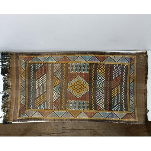 580 - A set of four tribal rugs, with geometric decoration, each 92 x 50 cm (4)