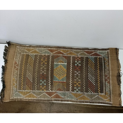 580 - A set of four tribal rugs, with geometric decoration, each 92 x 50 cm (4)