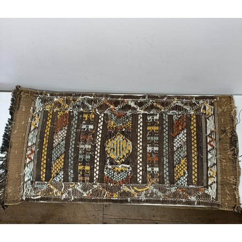 580 - A set of four tribal rugs, with geometric decoration, each 92 x 50 cm (4)