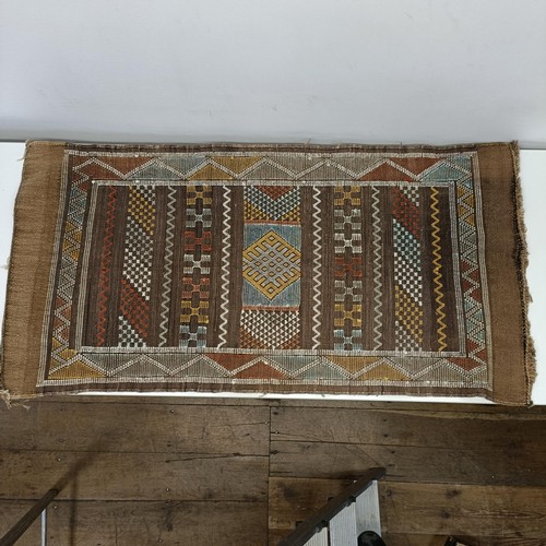 580 - A set of four tribal rugs, with geometric decoration, each 92 x 50 cm (4)