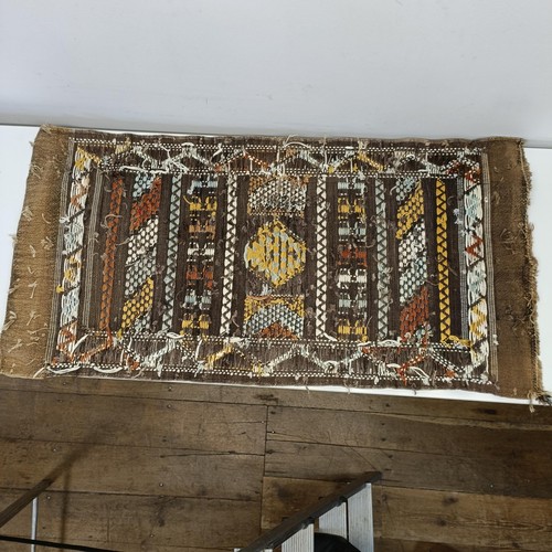 580 - A set of four tribal rugs, with geometric decoration, each 92 x 50 cm (4)