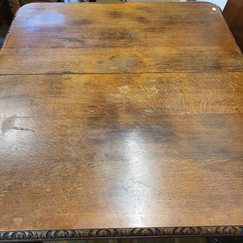 639 - A late Victorian carved oak dining table, inset three extra leaves, 298 cm wide