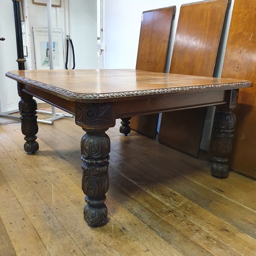 639 - A late Victorian carved oak dining table, inset three extra leaves, 298 cm wide