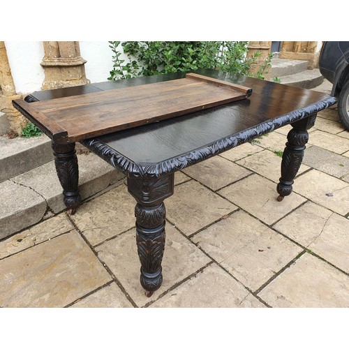 648 - An oak extending dining table, with one leaf, 136 cm wide, 182 cm wide including leaf