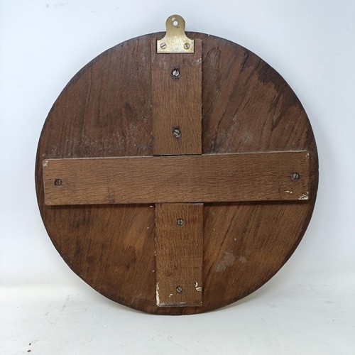 242 - A carved oak roundel, decorated horse, surrounded by oak leaves, 42 cm diameter, and a mahogany shel... 