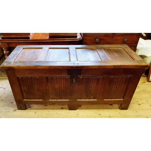 564 - A large oak coffer, with linen fold decoration, 170 cm wide