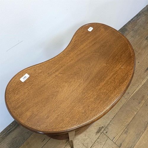 581 - An early 20th century mahogany kidney shaped two tier table, 65 cm wide