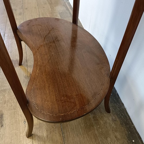 581 - An early 20th century mahogany kidney shaped two tier table, 65 cm wide