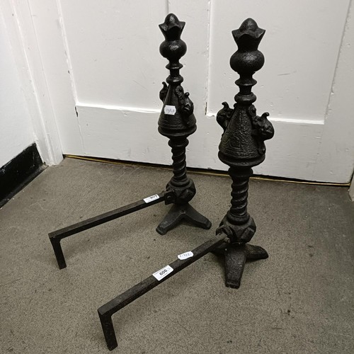 606 - A pair of cast iron fire dogs, 54 cm high