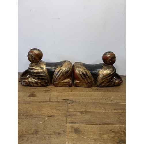 43 - A pair of Chinese carved wood figures, kneeling and holding a bowl, 70 cm wide (2)