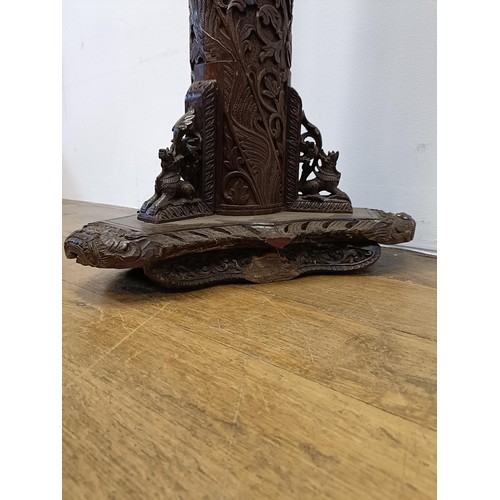 45 - A Chinese bamboo stand, carved foliate forms, on a triangular base, 85 cm high