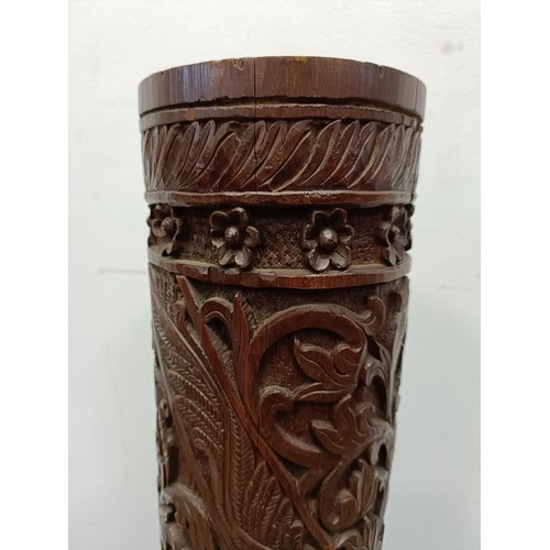 45 - A Chinese bamboo stand, carved foliate forms, on a triangular base, 85 cm high