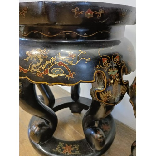 46 - A pair of Chinese lacquered vase stands, decorated dragons, 42 cm high x 33 cm diameter (2)