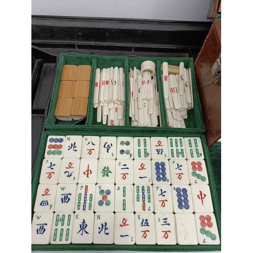 92 - A Mah-Jong set, in a leather case, and four stands (5)