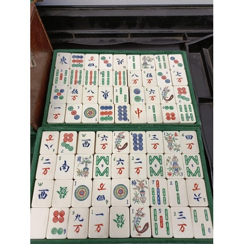 92 - A Mah-Jong set, in a leather case, and four stands (5)