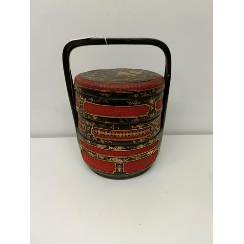 93 - A Chinese lacquered steamer, decorated figures, 30 cm high