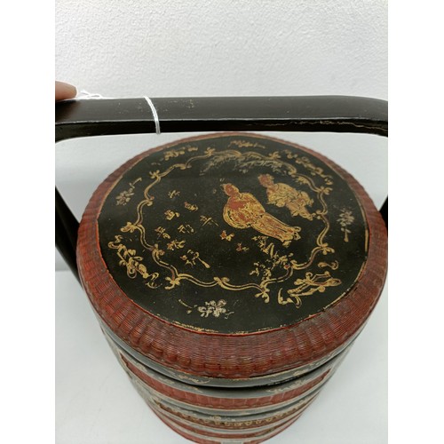 93 - A Chinese lacquered steamer, decorated figures, 30 cm high