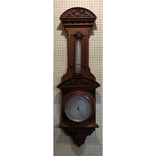 1094 - A wall in a carved walnut case, 106 cm high