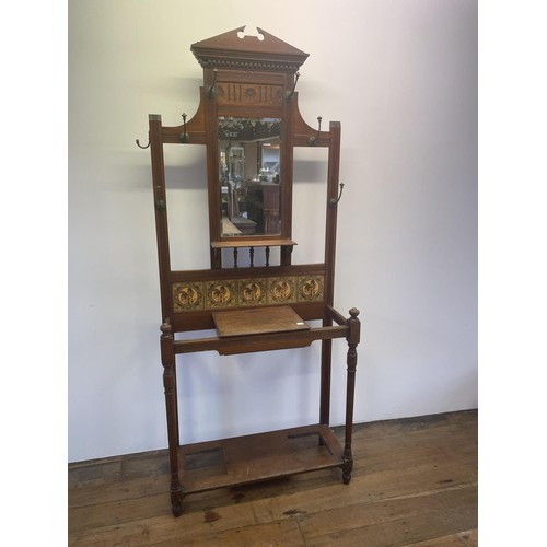 1187 - An early 20th century oak hall stand, inset with tiles, decorated flowers, 213 cm high x 85 cm wide