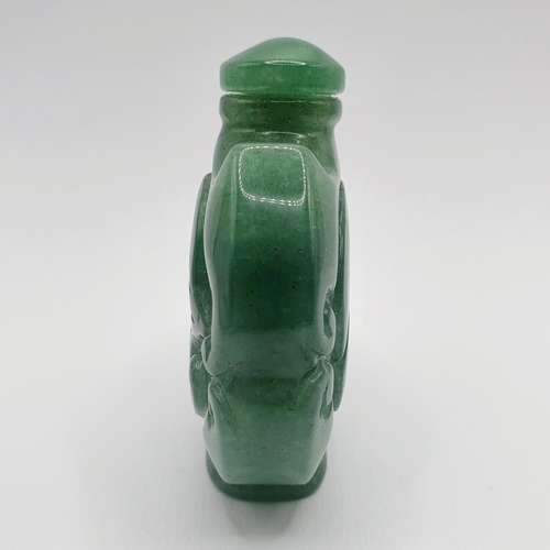 12 - A Chinese carved green stone snuff bottle, 6 cm high 
Provenance: From a single owner collection of ... 