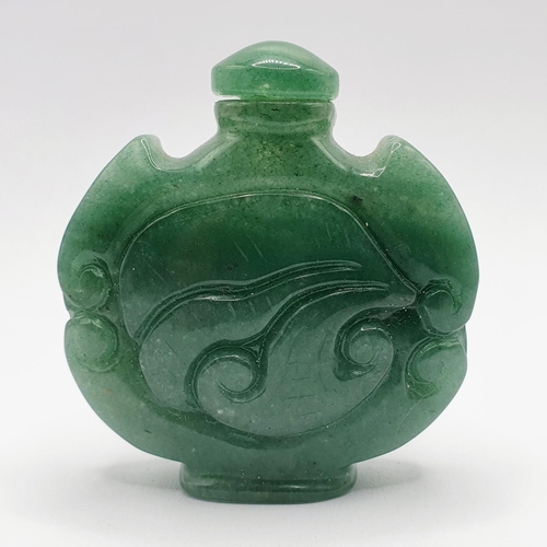 12 - A Chinese carved green stone snuff bottle, 6 cm high 
Provenance: From a single owner collection of ... 