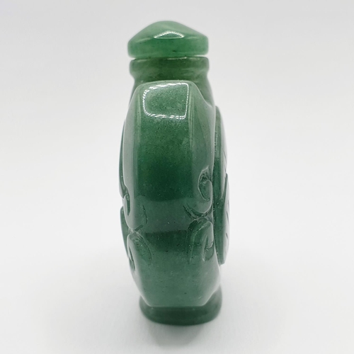 12 - A Chinese carved green stone snuff bottle, 6 cm high 
Provenance: From a single owner collection of ... 