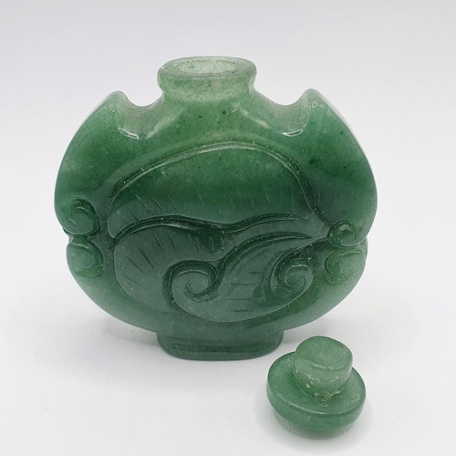 12 - A Chinese carved green stone snuff bottle, 6 cm high 
Provenance: From a single owner collection of ... 