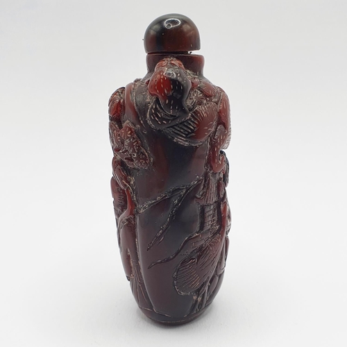 13 - A Chinese carved amber coloured snuff bottle, 7 cm high
Provenance: From a single owner collection o... 