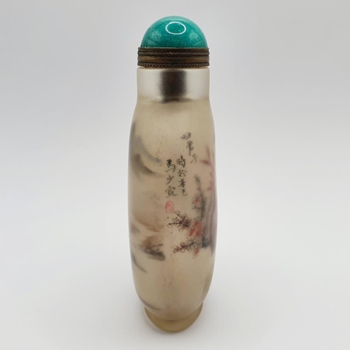 14 - A Chinese glass snuff bottle, the interior painted a landscape, with a turquoise stopper, 10 cm high... 