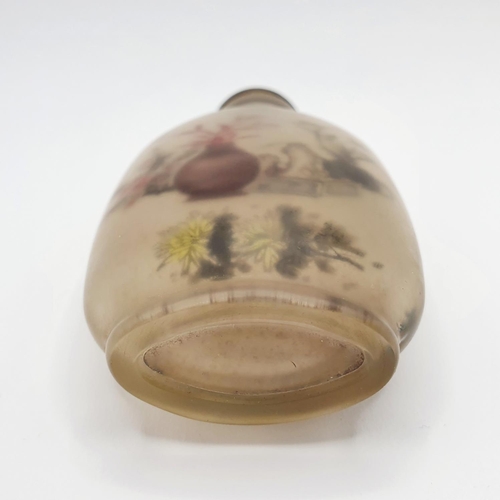 14 - A Chinese glass snuff bottle, the interior painted a landscape, with a turquoise stopper, 10 cm high... 