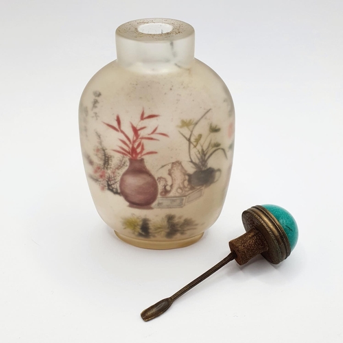 14 - A Chinese glass snuff bottle, the interior painted a landscape, with a turquoise stopper, 10 cm high... 