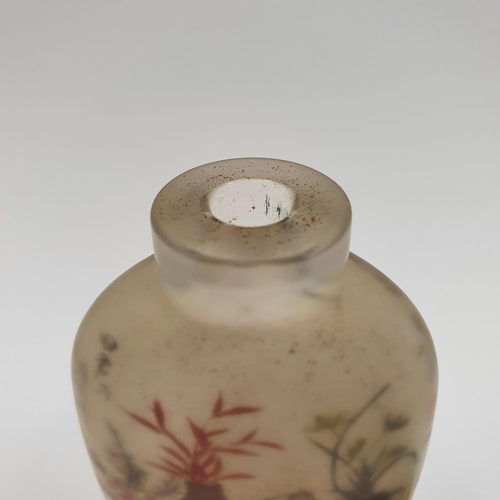 14 - A Chinese glass snuff bottle, the interior painted a landscape, with a turquoise stopper, 10 cm high... 