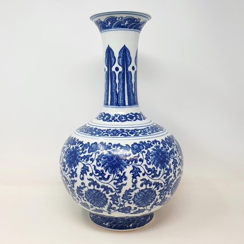 2 - A Chinese blue and white bottle vase, decorated flowers in underglaze blue, bears a Qianlong mark, 3... 