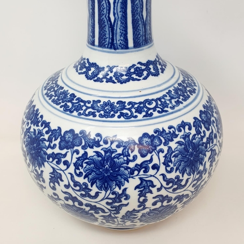 2 - A Chinese blue and white bottle vase, decorated flowers in underglaze blue, bears a Qianlong mark, 3... 