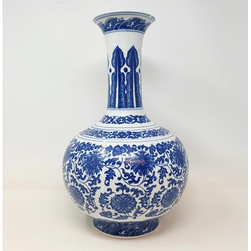 2 - A Chinese blue and white bottle vase, decorated flowers in underglaze blue, bears a Qianlong mark, 3... 