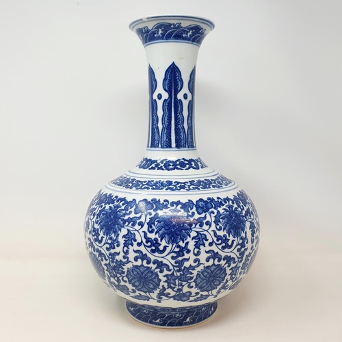 2 - A Chinese blue and white bottle vase, decorated flowers in underglaze blue, bears a Qianlong mark, 3... 