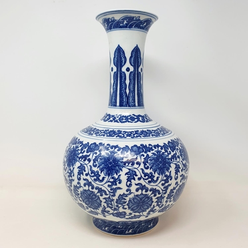 2 - A Chinese blue and white bottle vase, decorated flowers in underglaze blue, bears a Qianlong mark, 3... 