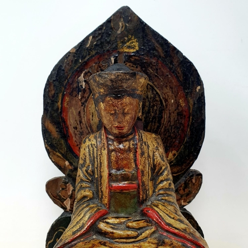 38 - A Chinese carved wood and painted figure of a deity, 23 cm high