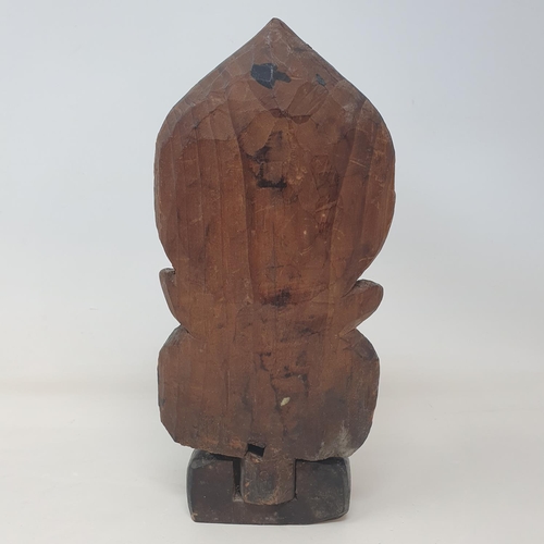 38 - A Chinese carved wood and painted figure of a deity, 23 cm high