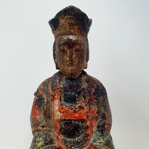 39 - A Chinese carved wood and painted figure of a deity, 27 cm high