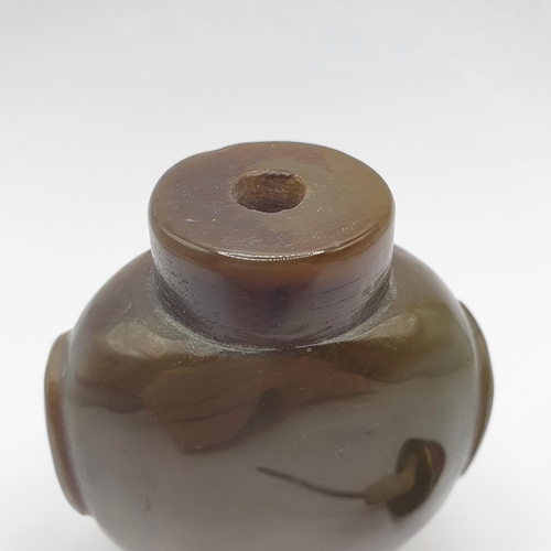 4 - A Chinese green stone snuff bottle, with an amber coloured stone stopper, 9 cm high   
Provenance: F... 