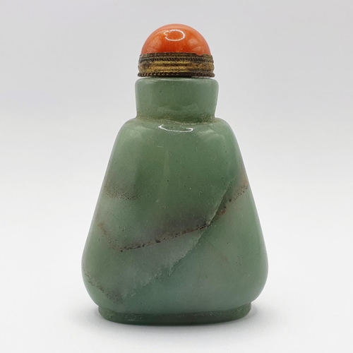 5 - A Chinese green hardstone snuff bottle, with a coral coloured stopper, 7 cm high Provenance: From a ... 