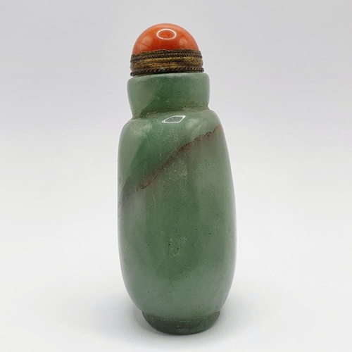 5 - A Chinese green hardstone snuff bottle, with a coral coloured stopper, 7 cm high Provenance: From a ... 