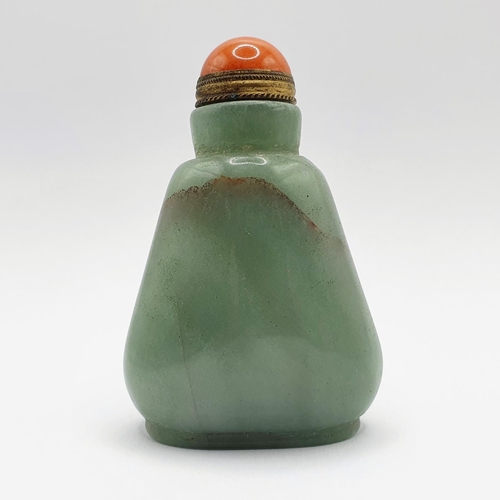 5 - A Chinese green hardstone snuff bottle, with a coral coloured stopper, 7 cm high Provenance: From a ... 