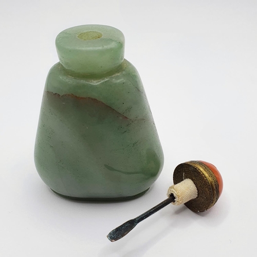 5 - A Chinese green hardstone snuff bottle, with a coral coloured stopper, 7 cm high Provenance: From a ... 