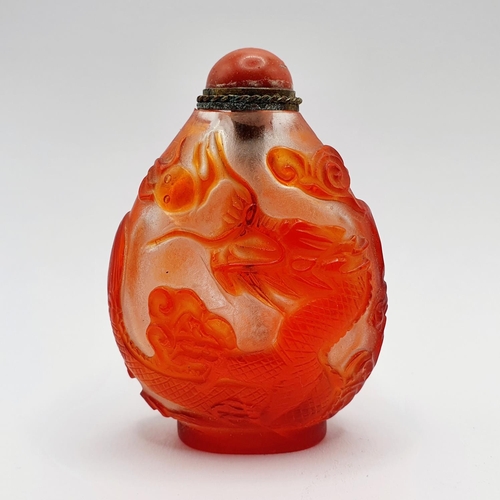 8 - A Chinese red and white cased glass snuff bottle, with a coral stopper, 6 cm high
Provenance: From a... 