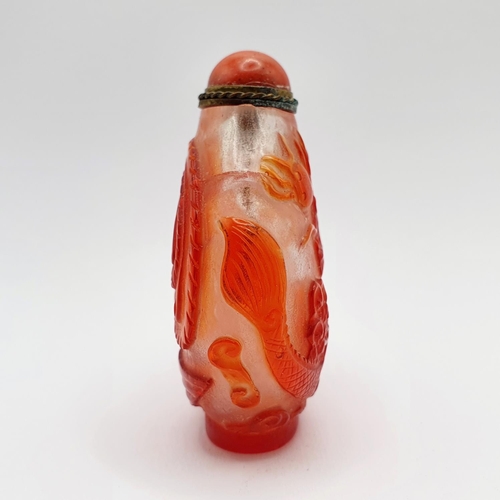 8 - A Chinese red and white cased glass snuff bottle, with a coral stopper, 6 cm high
Provenance: From a... 