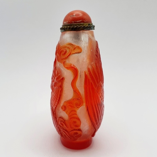 8 - A Chinese red and white cased glass snuff bottle, with a coral stopper, 6 cm high
Provenance: From a... 